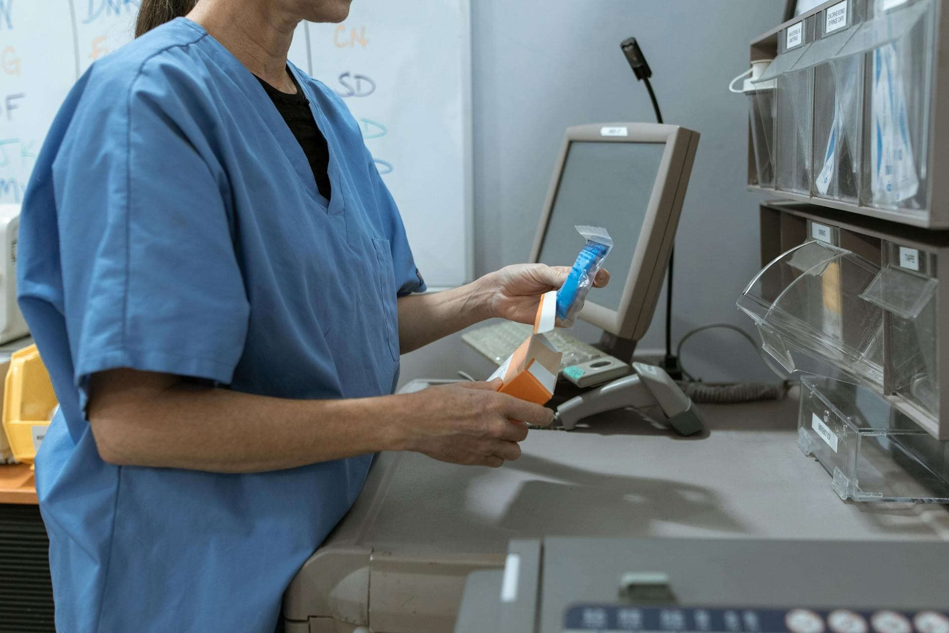 Pharmacist scanning medication at counter